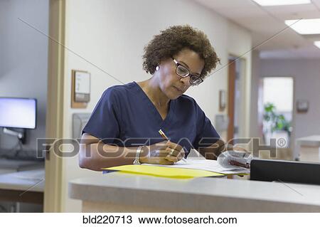 African American nurse writing in hospital View Large Photo Image Stock Image - African American nurse writing in hospital. Fotosearch