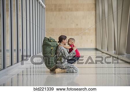 African American soldier hugging son in airport View Large Photo Image Stock Photo - African American soldier hugging son in airport. Fotosearch