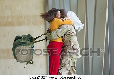 African American soldier hugging wife in airport View Large Photo Image Stock Photo - African American soldier hugging wife in airport. Fotosearch
