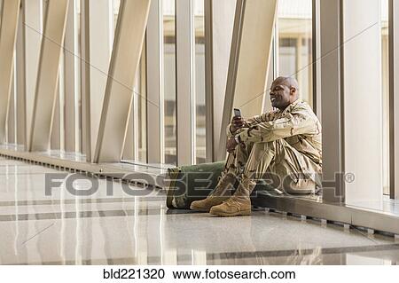 African American soldier using cell phone in airport View Large Photo Image Stock Image - African American soldier using cell phone in airport. Fotosearch