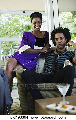 Picture - African American woman at cocktail party with boyfriend. Fotosearch