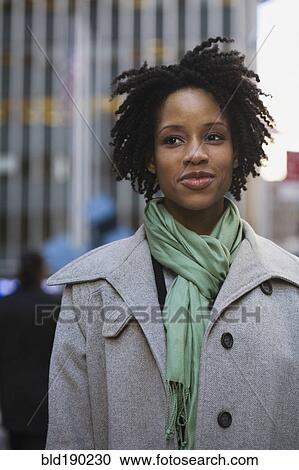 Stock Image - African American woman in urban scene. Fotosearch