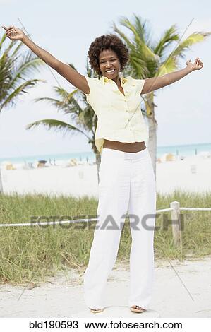 Stock Image - African American woman with arms raised. Fotosearch