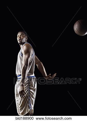 Stock Image - African basketball player passing basketball. Fotosearch