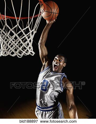 Stock Photo - African basketball player scoring. Fotosearch