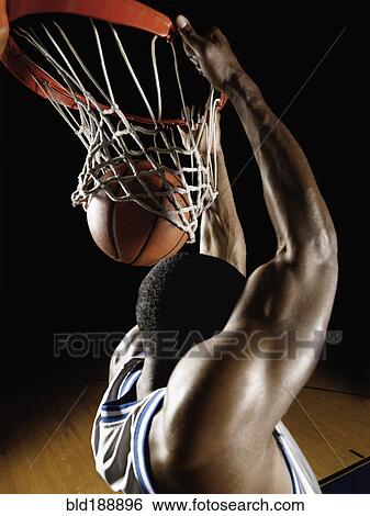 Stock Photograph - African basketball player scoring. Fotosearch