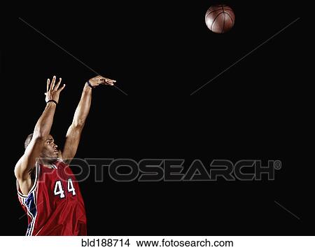 African basketball player shooting basketball View Large Photo Image Picture - African basketball player shooting basketball. Fotosearch