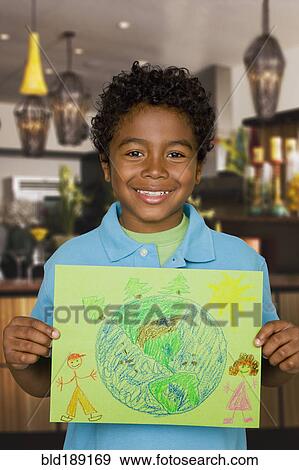 African boy holding drawing of the Earth View Large Photo Image Stock Photo - African boy holding drawing of the Earth. Fotosearch