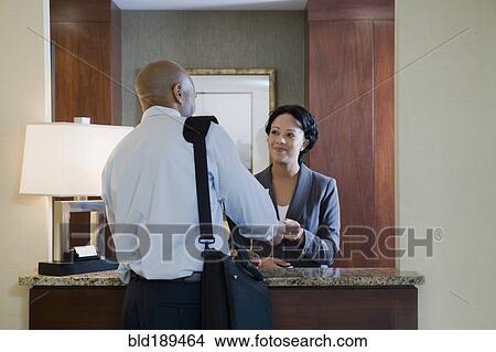 Picture - African businessman at hotel check-in. Fotosearch