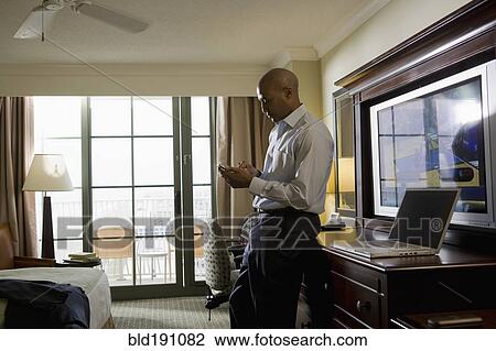 African businessman in hotel using cell phone View Large Photo Image Stock Image - African businessman in hotel using cell phone. Fotosearch