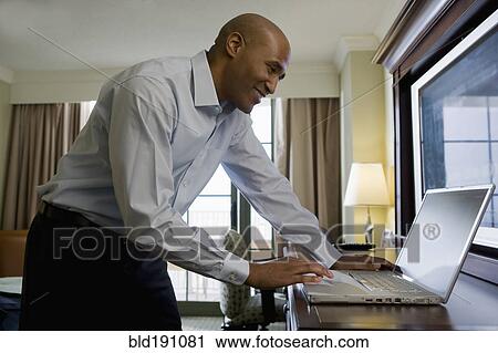 African businessman in hotel using laptop View Large Photo Image Stock Image - African businessman in hotel using laptop. Fotosearch