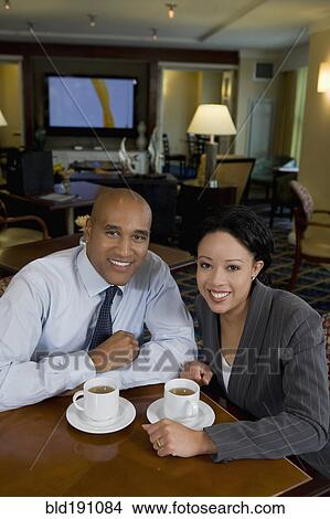 Picture - African businesspeople drinking coffee. Fotosearch