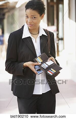 African businesswoman holding wallet open View Large Photo Image Stock Image - African businesswoman holding wallet open. Fotosearch