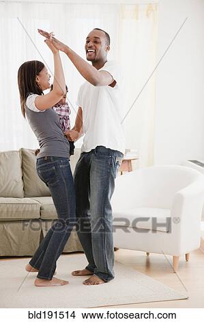 African couple and baby dancing in living room View Large Photo Image Picture - African couple and baby dancing in living room. Fotosearch