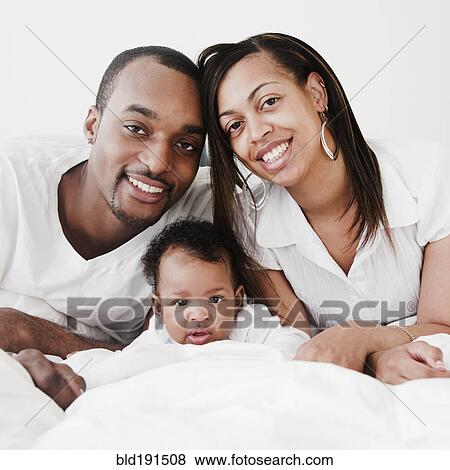 Stock Photo - African couple and baby. Fotosearch