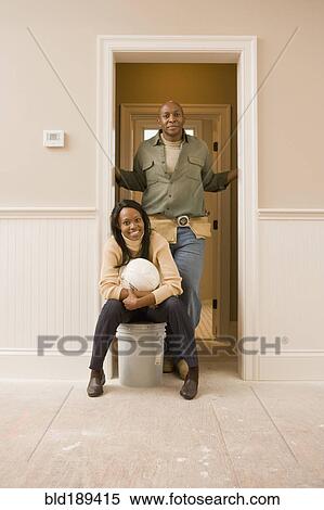 Stock Photography - African couple doing home improvement. Fotosearch