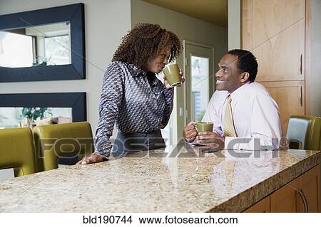 African couple drinking coffee in modern kitchen View Large Photo Image Picture - African couple drinking coffee in modern kitchen. Fotosearch