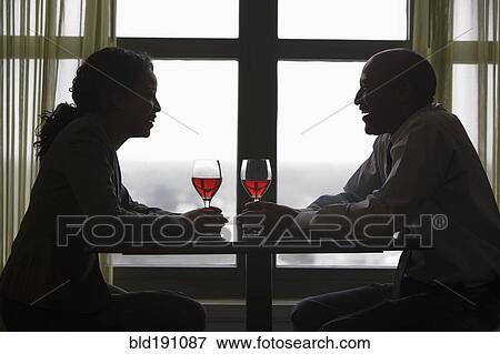 Stock Photo - African couple drinking red wine. Fotosearch
