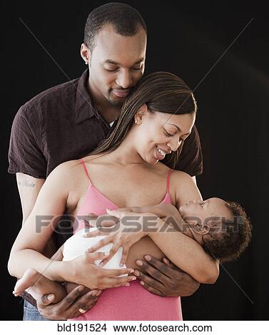 African couple holding sleeping baby View Large Photo Image Picture - African couple holding sleeping baby. Fotosearch