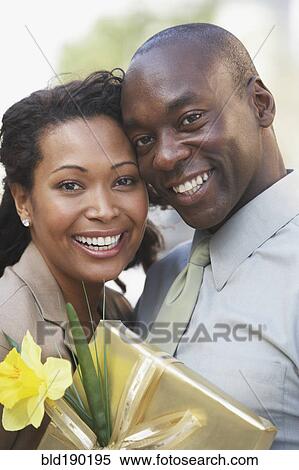 African couple hugging and holding gift View Large Photo Image Stock Photography - African couple hugging and holding gift. Fotosearch