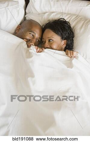African couple in bed under blanket View Large Photo Image Stock Photo - African couple in bed under blanket. Fotosearch