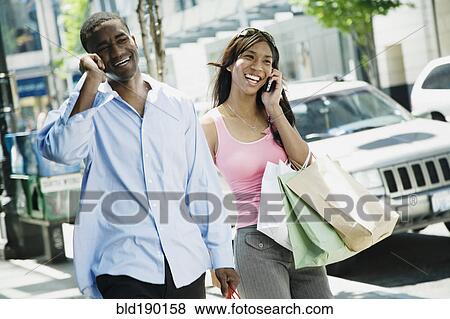 African couple talking on cell phones View Large Photo Image Stock Photo - African couple talking on cell phones. Fotosearch