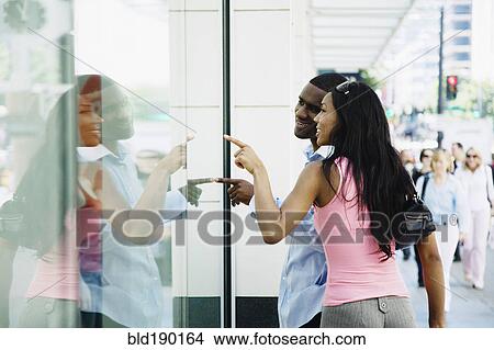 Picture - African couple window shopping. Fotosearch