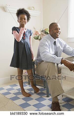 Stock Image - African father and daughter playing together. Fotosearch