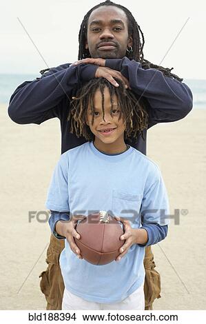 Picture - African father and son with football. Fotosearch