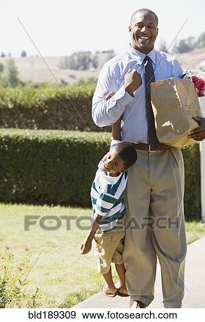 African father carrying groceries and son View Large Photo Image Stock Photo - African father carrying groceries and son. Fotosearch