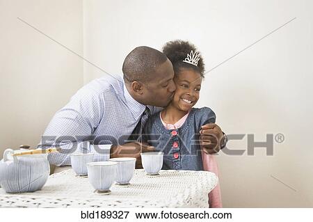 African father kissing daughter with tiara View Large Photo Image Stock Photo - African father kissing daughter with tiara. Fotosearch