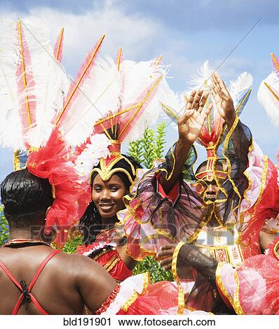 Stock Image - African group dancing in traditional clothing. Fotosearch
