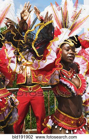 Stock Image - African group dancing in traditional clothing. Fotosearch