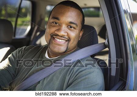 Stock Photo - African man driving car. Fotosearch