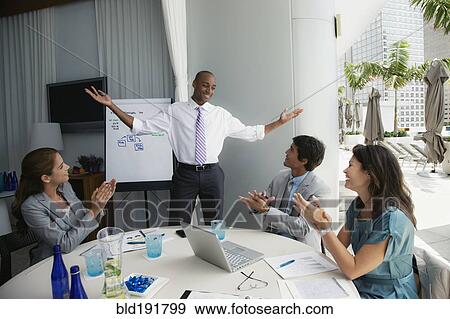 Stock Photo - African man giving presentation on patio. Fotosearch