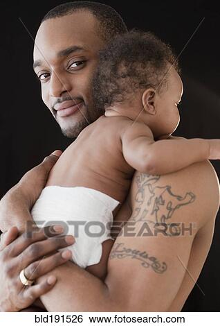 African man holding baby View Large Photo Image Stock Photograph - African man holding baby. Fotosearch