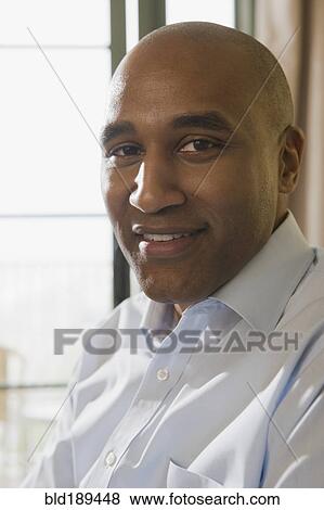 Stock Photo - African man looking at camera. Fotosearch