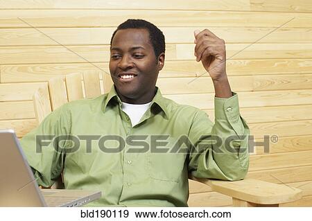 African man looking at laptop View Large Photo Image Stock Photo - African man looking at laptop. Fotosearch