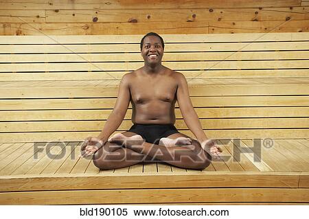 Stock Photography - African man meditation in sauna. Fotosearch