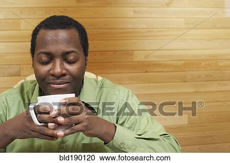 African man smelling cup of coffee View Large Photo Image Stock Image - African man smelling cup of coffee. Fotosearch