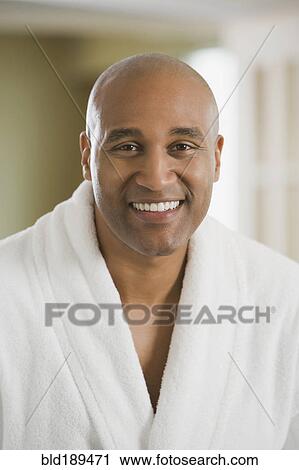 Stock Image - African man smiling in bathrobe. Fotosearch