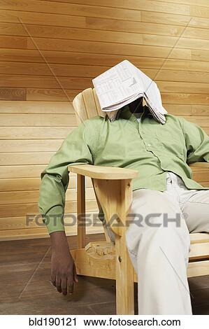 African man with newspaper over face View Large Photo Image Stock Image - African man with newspaper over face. Fotosearch