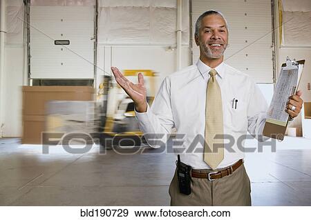 Stock Photo - African man working in warehouse. Fotosearch