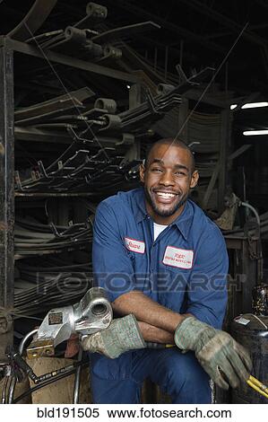 African mechanic in repair shop View Large Photo Image Stock Photography - African mechanic in repair shop. Fotosearch