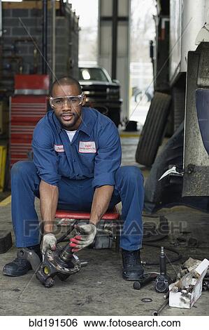 Stock Photograph - African mechanic working in repair shop. Fotosearch