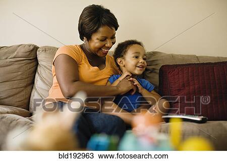 Stock Image - African mother playing with young son. Fotosearch