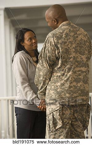 Stock Photography - African soldier and girlfriend holding hands. Fotosearch