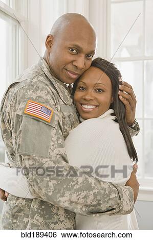 Stock Photograph - African soldier and girlfriend hugging. Fotosearch