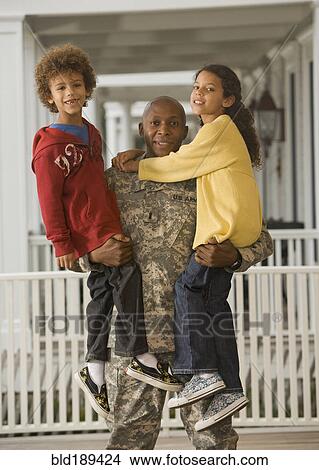 African soldier holding son and daughter View Large Photo Image Picture - African soldier holding son and daughter. Fotosearch