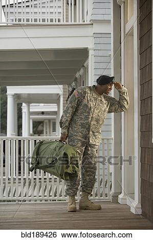 Stock Photograph - African soldier standing on front stoop. Fotosearch